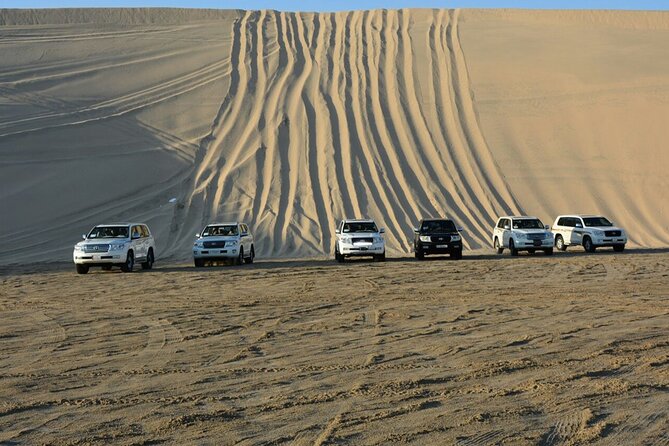 Desert Safari, Camel ride and Inland Sea Tour - Photographing the dunes beside the blue sea