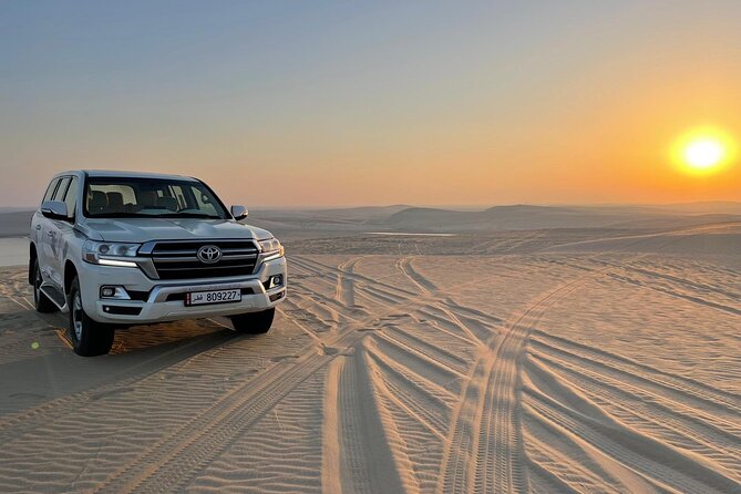 Doha: Desert Safari, Sand Boarding, Camel Ride & Inland Sea Tour - Sandboarding on the dunes