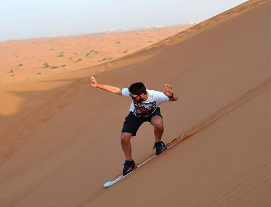 Doha: InlandSea Tour,Camel,Sand Boarding With All Activities - Sandboarding down the dunes