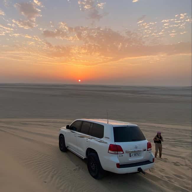 Doha Qatar : sealine adventure Camel Ride sandboard Sunset - Sandboarding from a high dune